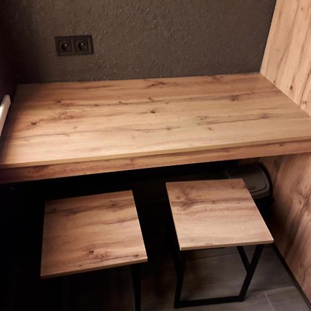 Full House Capsule Hostel Rivne Ngoại thất bức ảnh A table made of wood